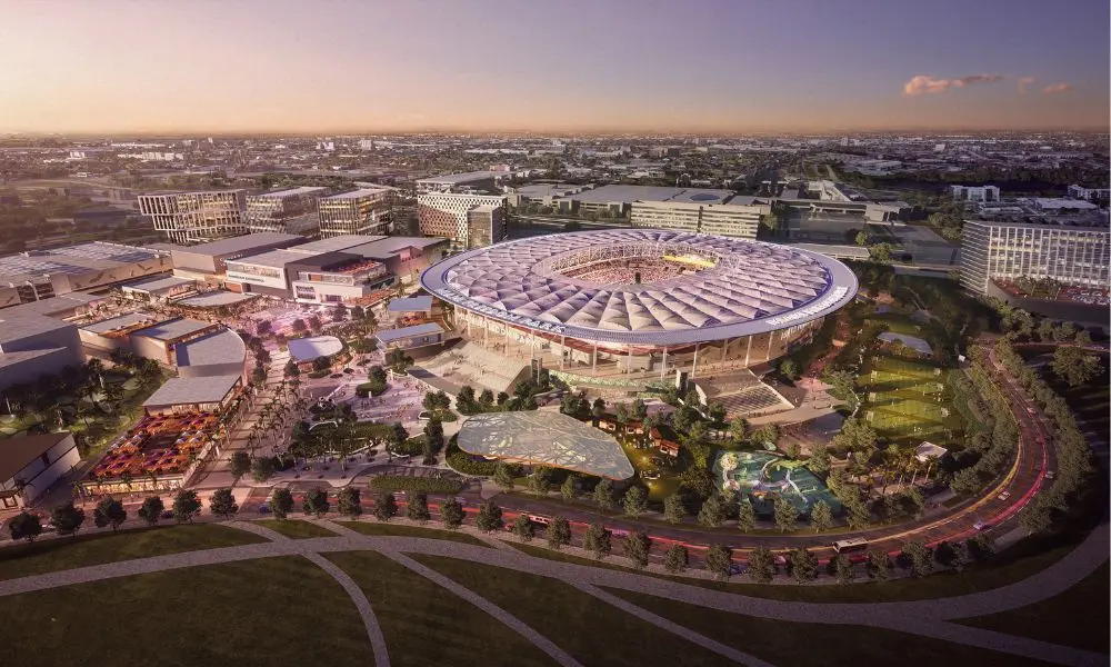 Freedom Park: Stadium & Mixed-Use Urban Development A large stadium with a futuristic roof design, surrounded by commercial and green spaces in a mixed-use urban development.