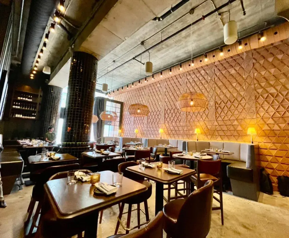 bar-chica-dining-area The interior of Bar Chica in Toronto, featuring warm ambient lighting, modern decor, and cozy seating arrangements.