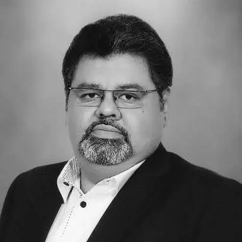 Amer Ahmed – Finance Expert at OHS Global Black and white portrait of Amer Ahmed, Head of Finance at OHS Global.
